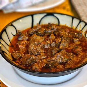 Rich and flavorful lamb curry served in a decorative bowl. Perfect for culinary enthusiasts.